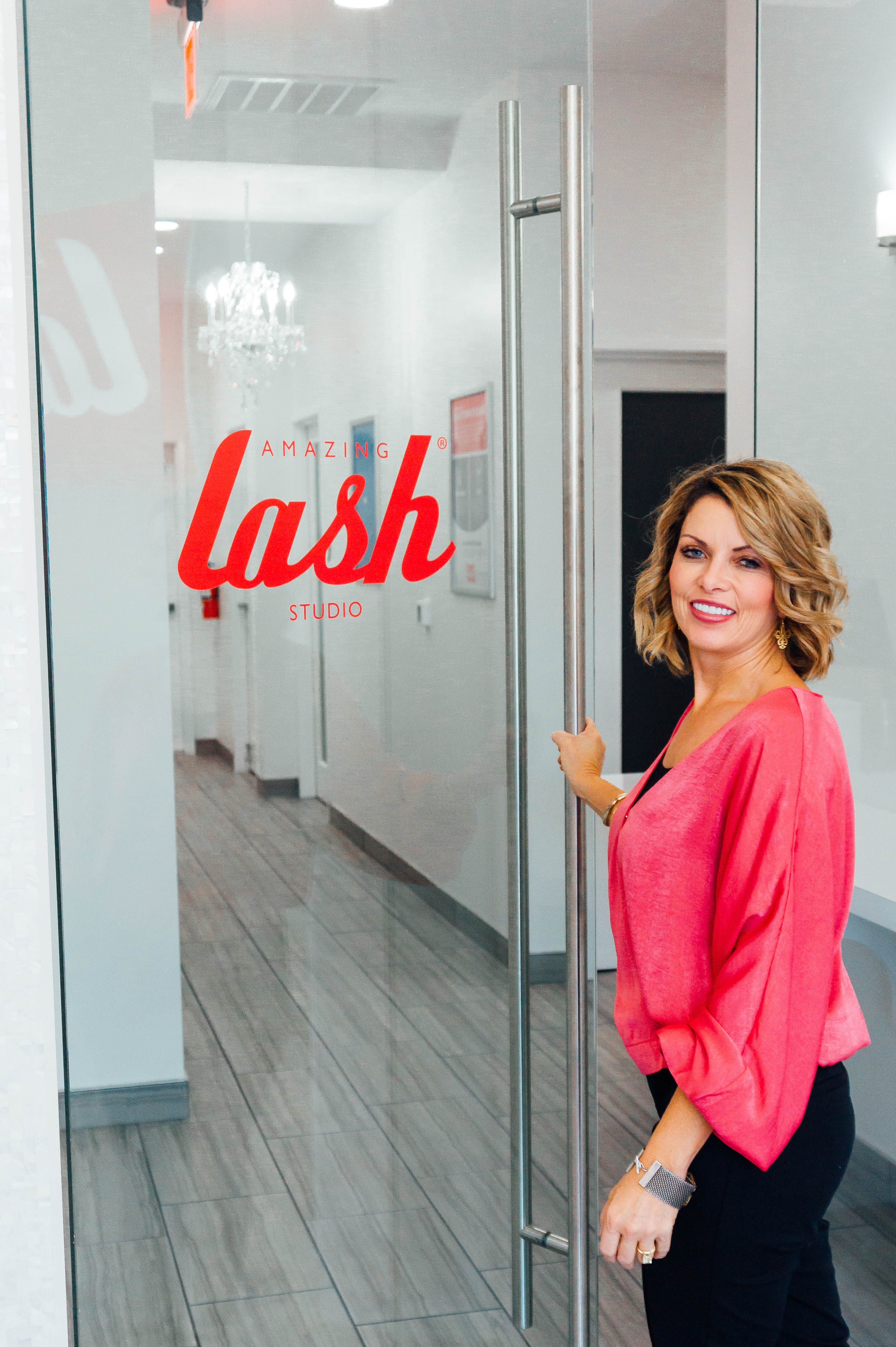 Amazing Lash Studio Monroe front door with woman welcoming