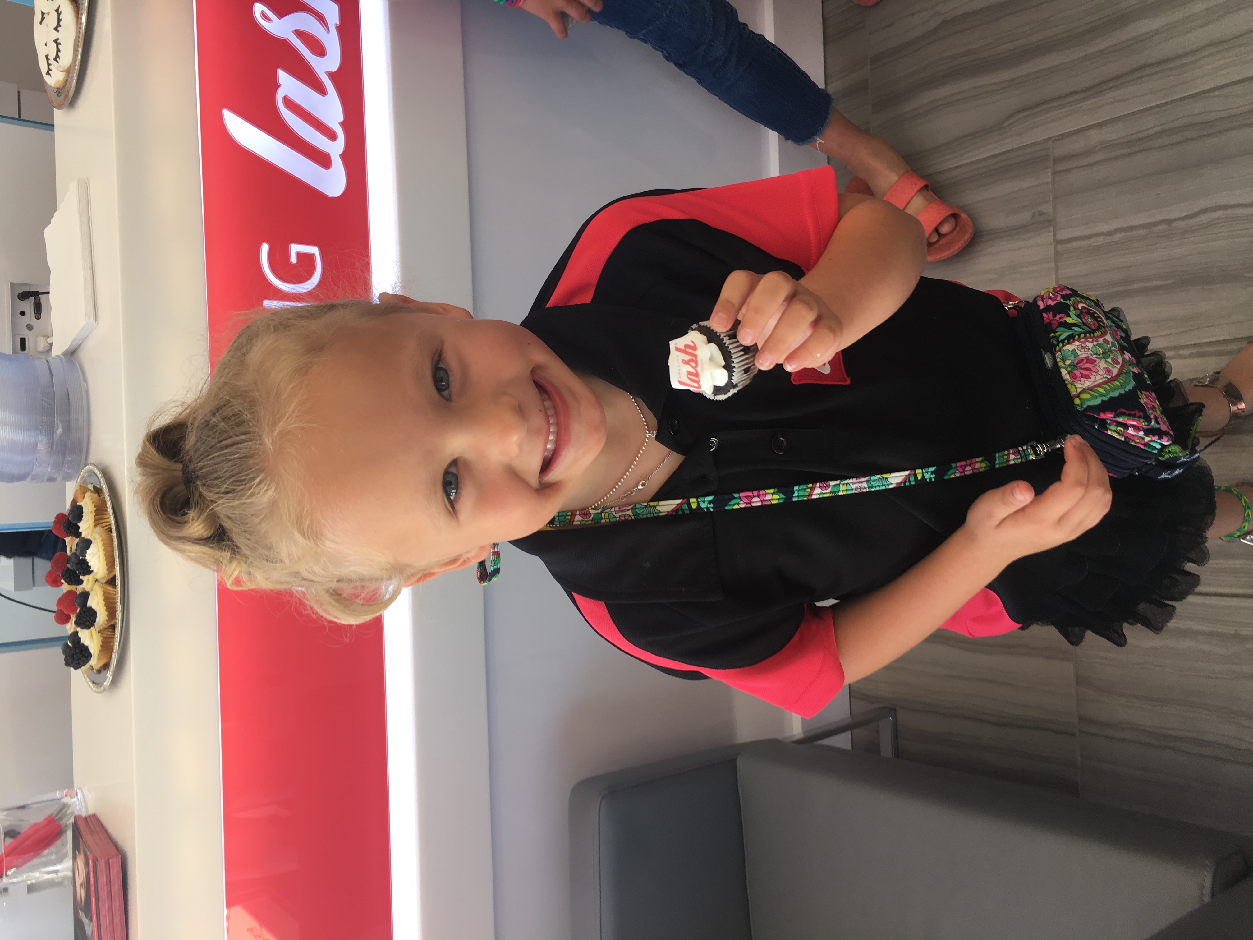 girl enjoying an Amazing Lash cupcake