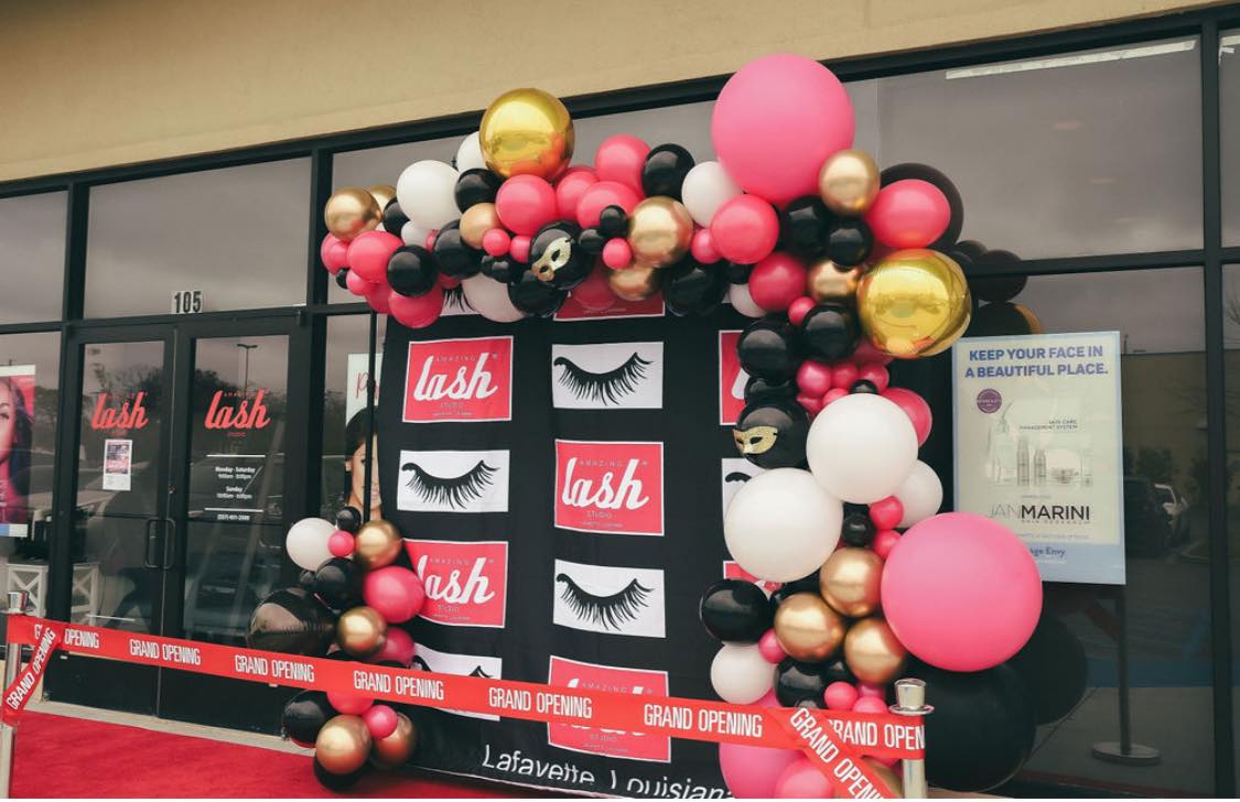 Amazing Lash Studio storefront grand opening with balloons