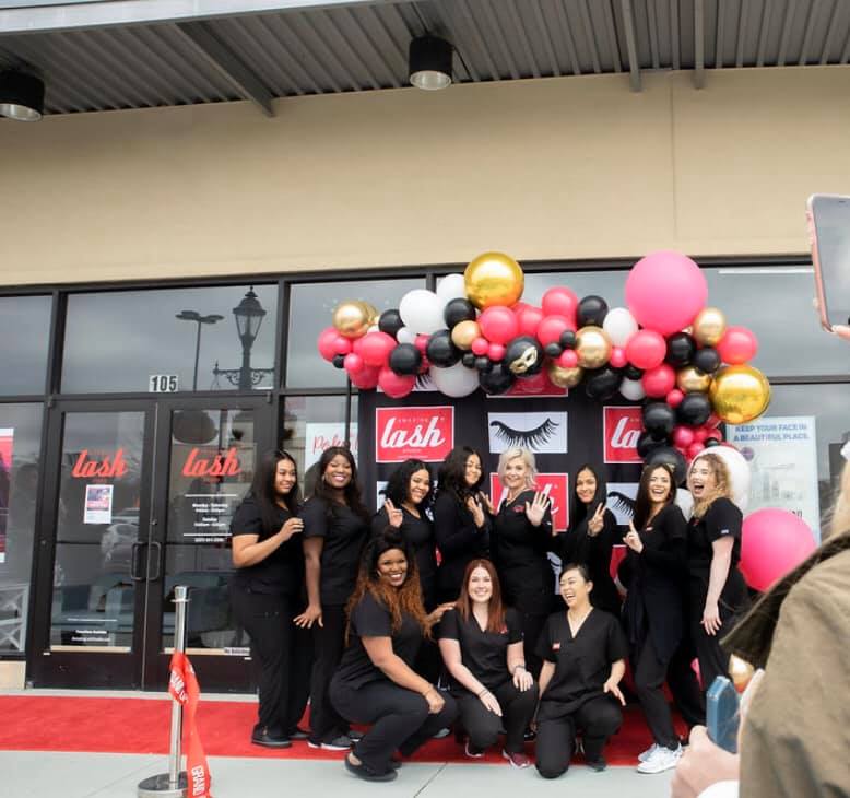 group of Amazing Lash Studio team in front of studio